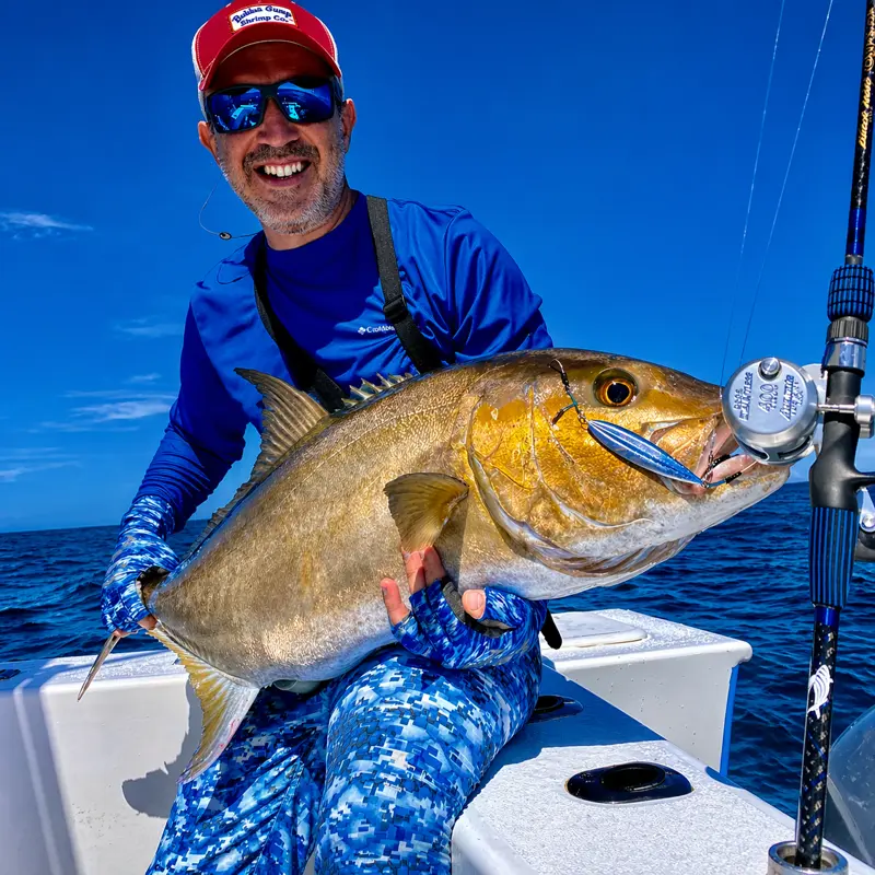 Captain Willy holding large golden fish on private fishing boat in Tamarindo